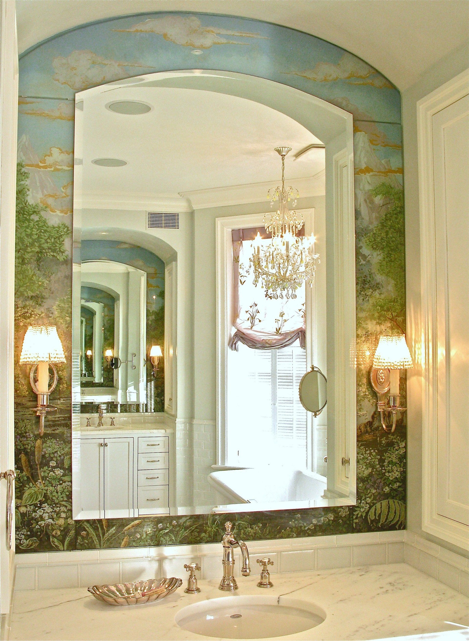 A bathroom with a large mirror and a sink