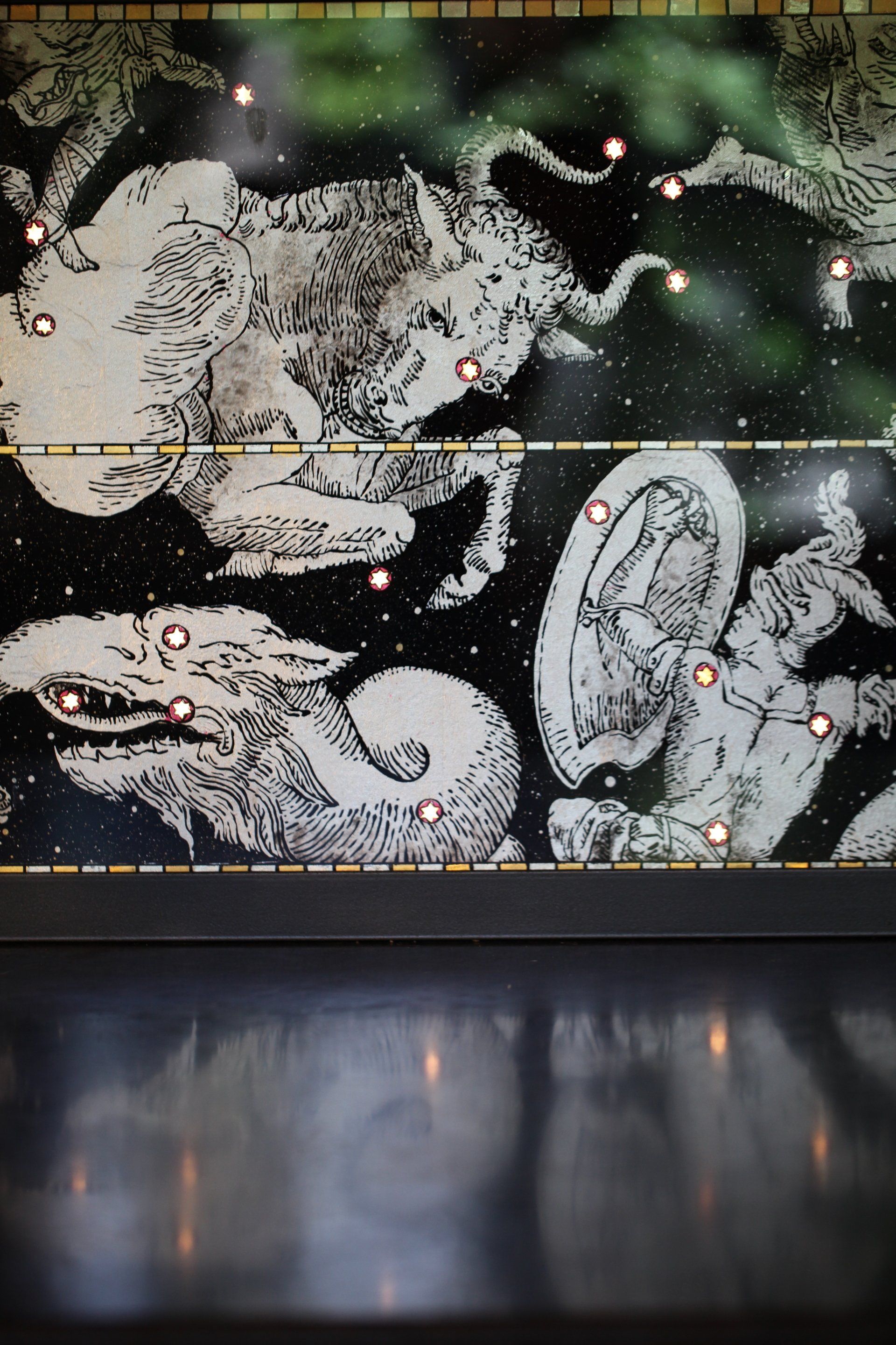 A black and white drawing of a constellation on a wall