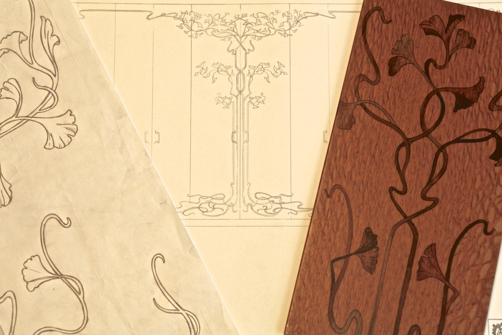 A drawing of a tree is on a piece of paper next to a piece of wood