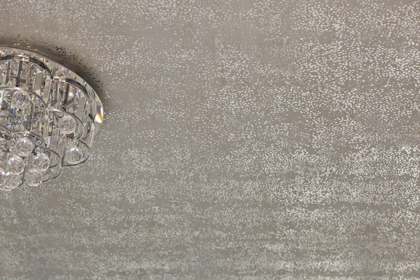 A chandelier is hanging from the ceiling of a room.