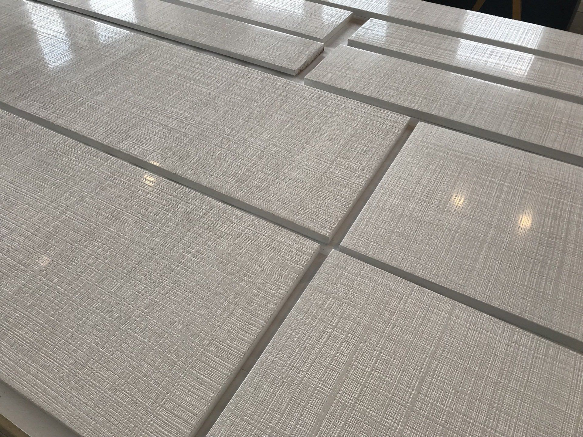 A row of white tiles sitting on top of each other on a table.