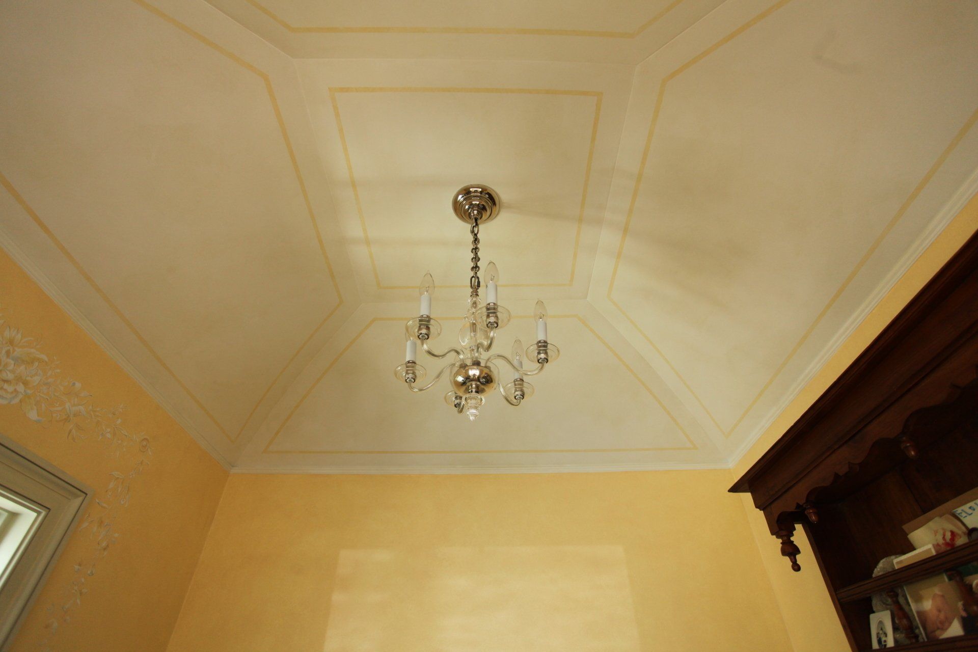 A chandelier is hanging from the ceiling of a room