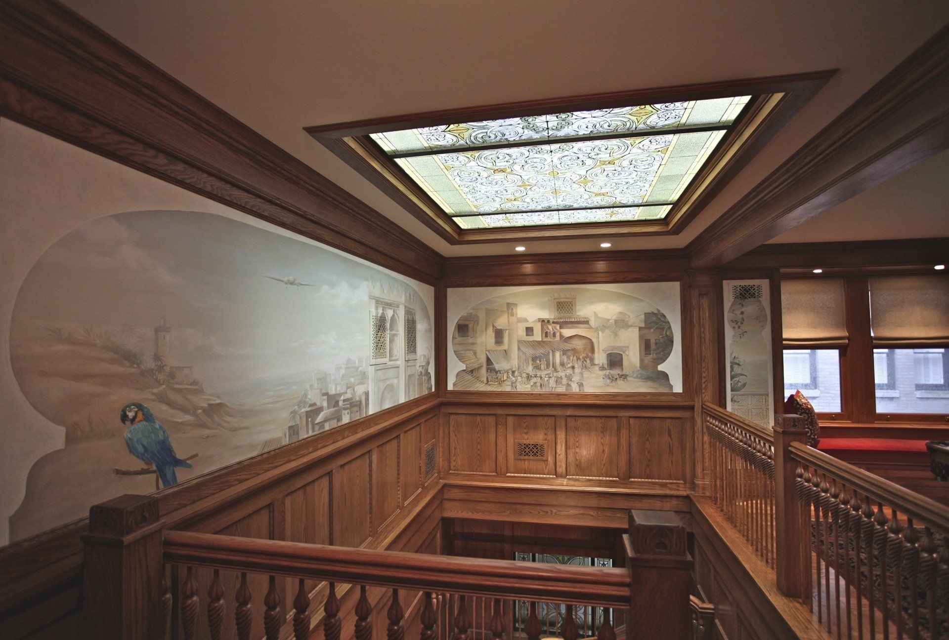 A staircase with a painting of a parrot on the wall
