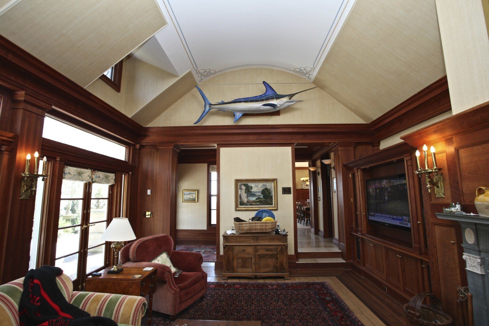 A living room with a shark hanging from the ceiling