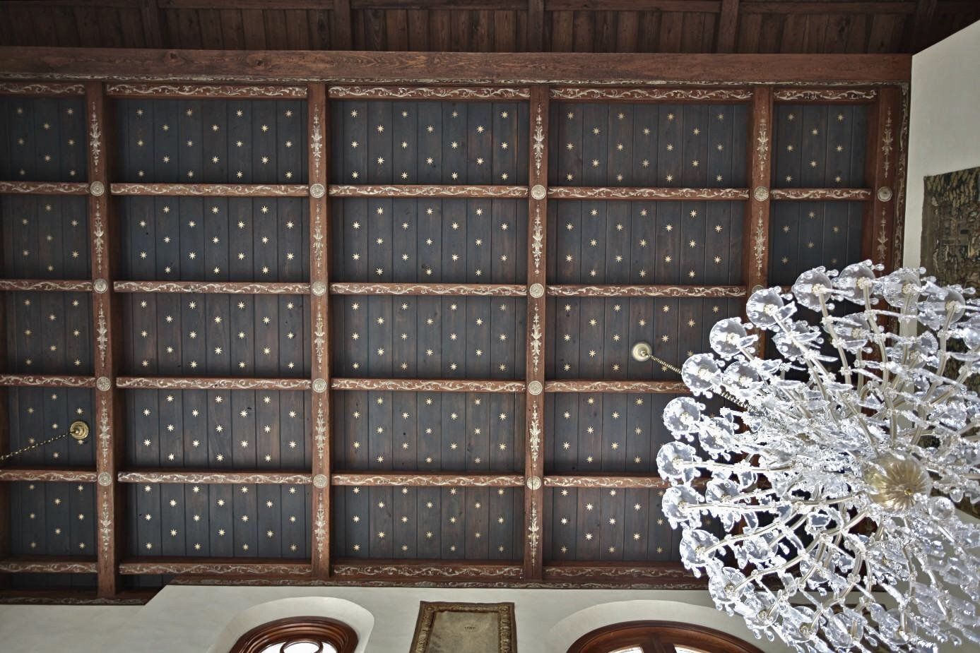 A chandelier is hanging from the ceiling of a building