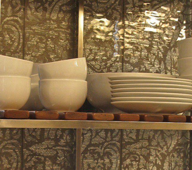 A shelf with bowls and plates on it