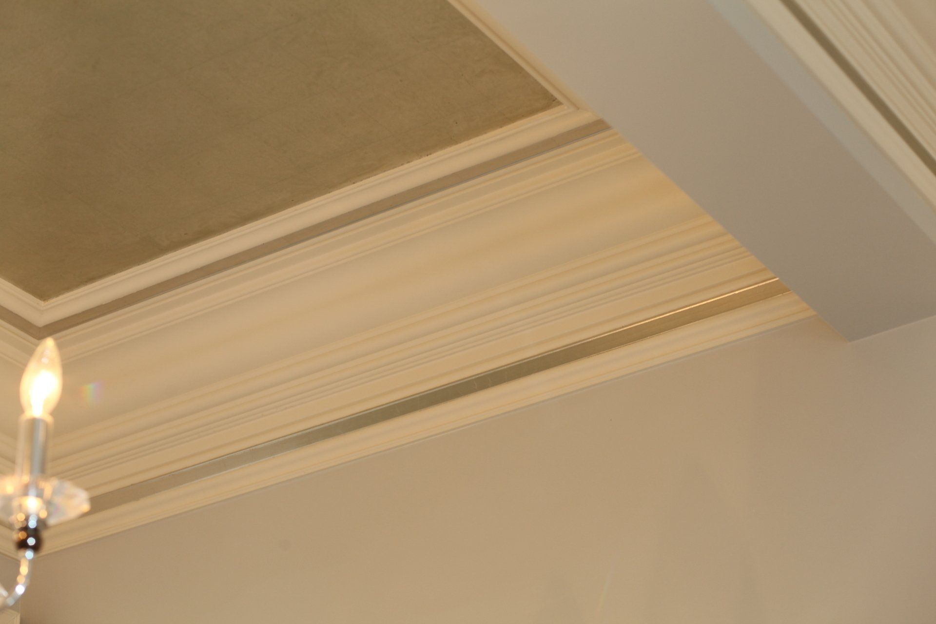 A chandelier is hanging from the ceiling of a room