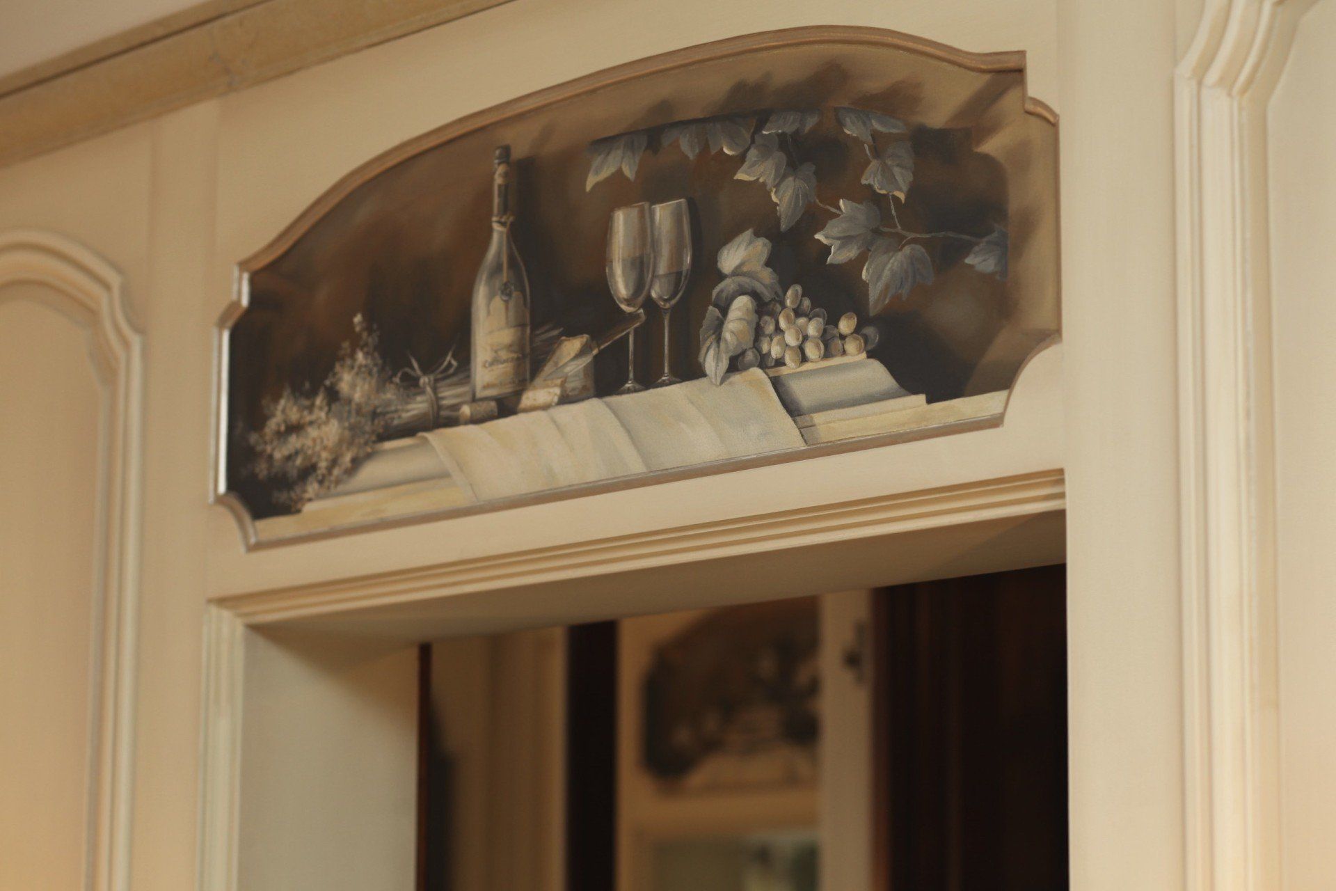 A doorway with a painting of a bottle of wine and glasses on it