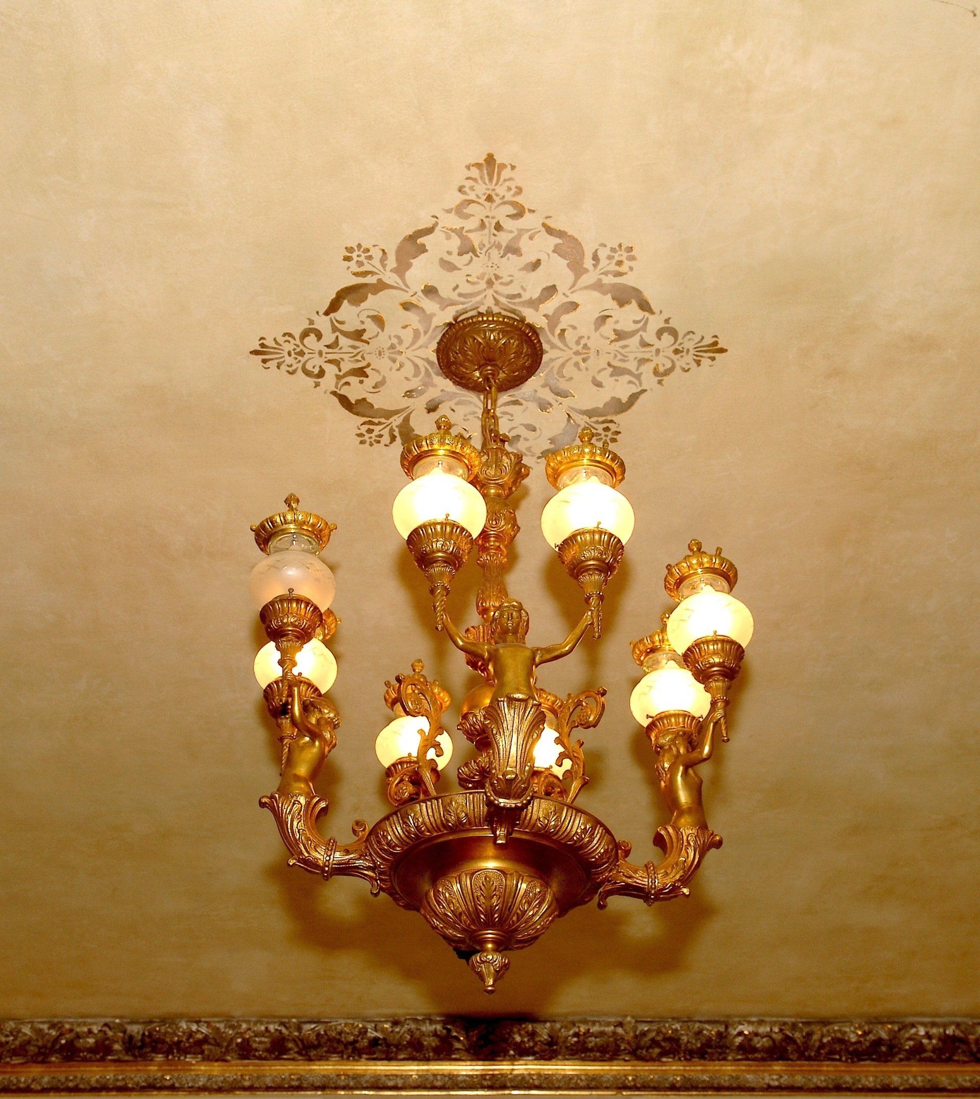 A gold chandelier is hanging from the ceiling