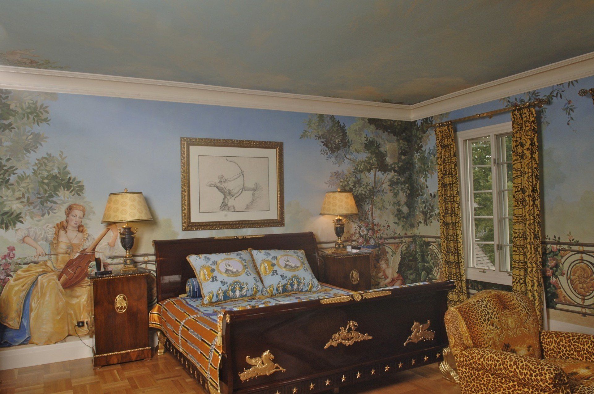 A bedroom with a painting on the wall above the bed