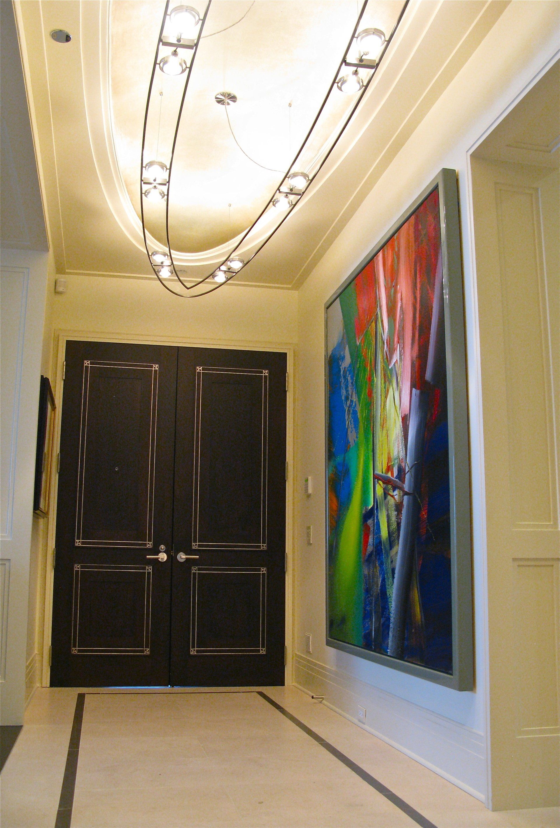 A hallway with a large painting on the wall