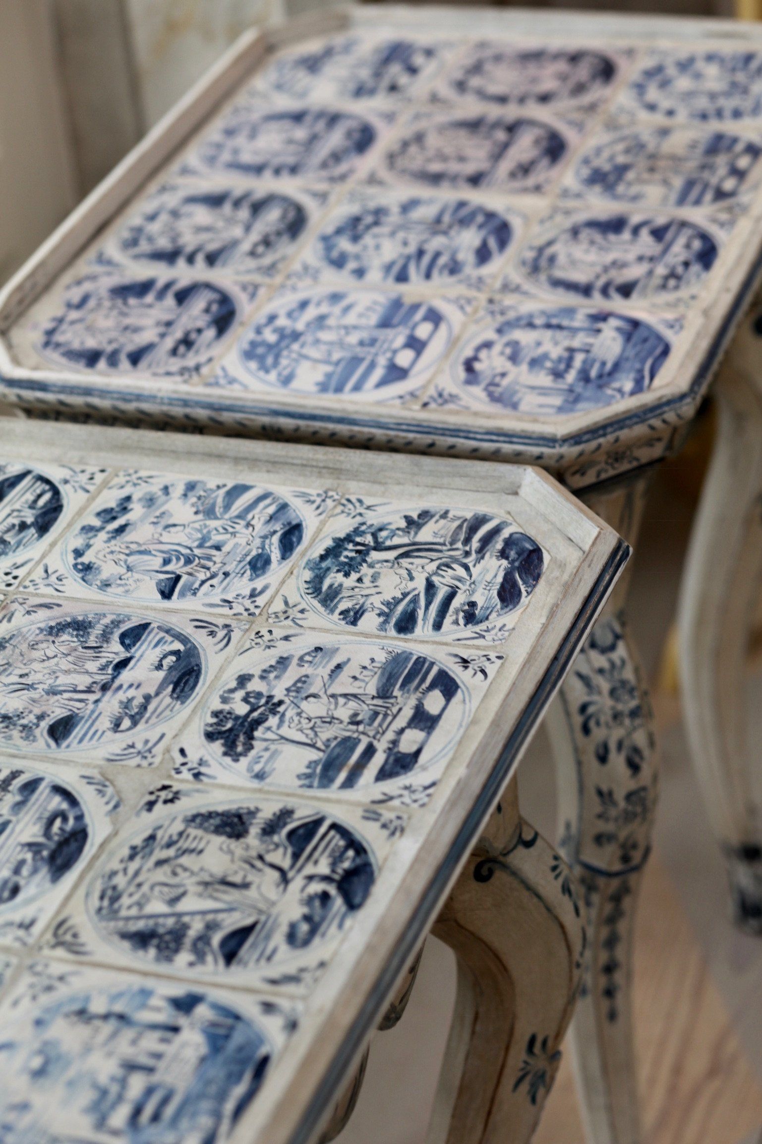 A couple of tables with blue and white tiles on them