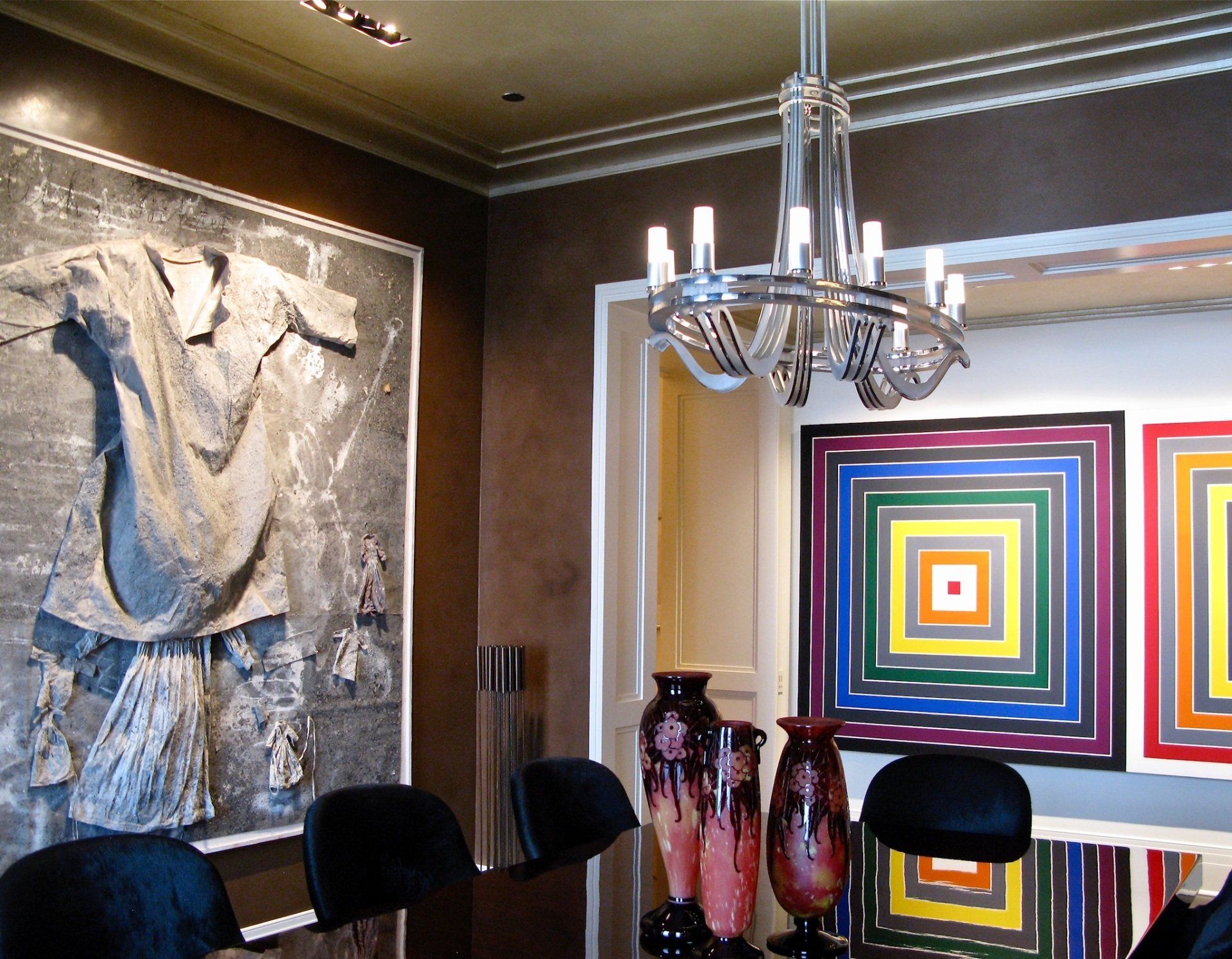 A dining room with a large painting on the wall
