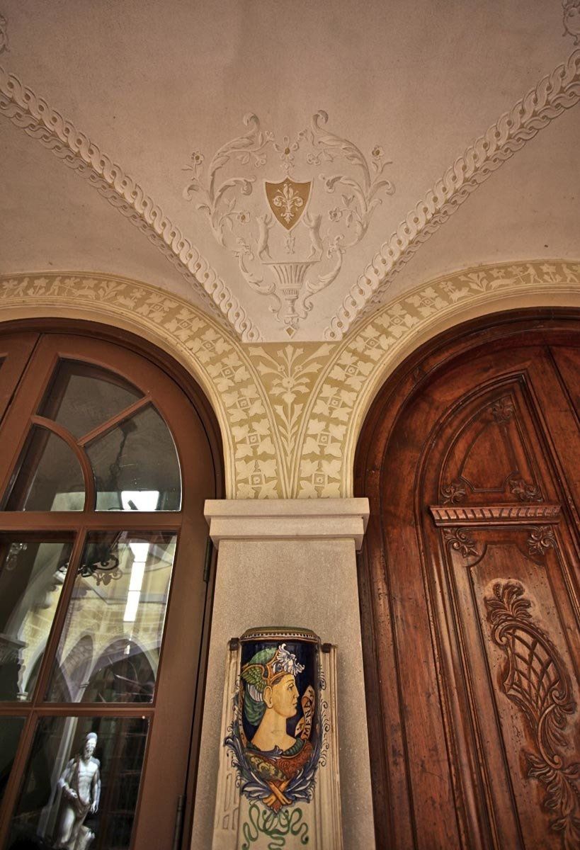 There is a statue of a woman on the wall next to a door.