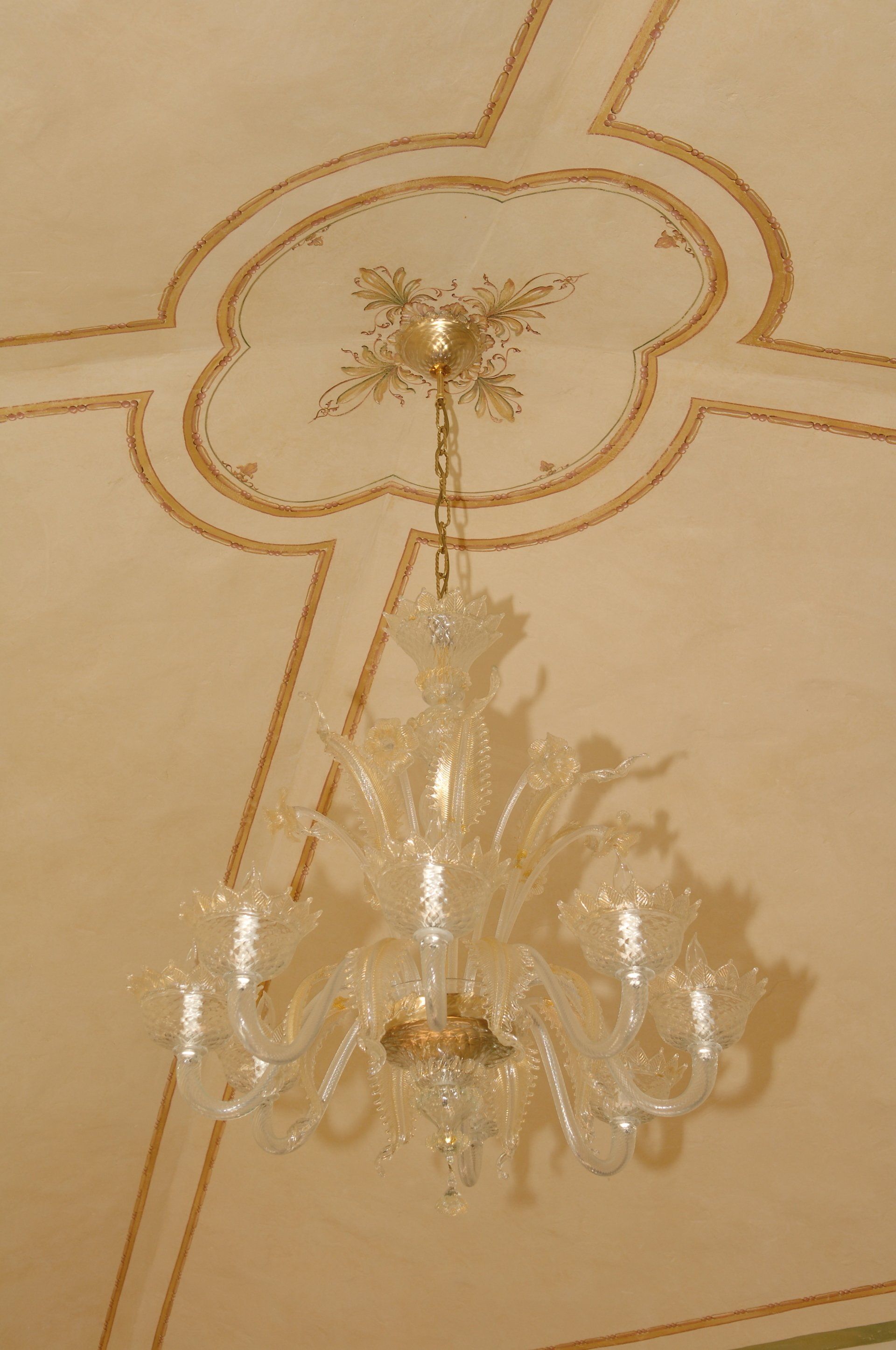 A chandelier is hanging from the ceiling of a room.