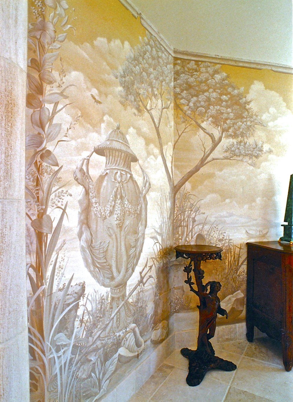 A corner of a room with a painting on the wall
