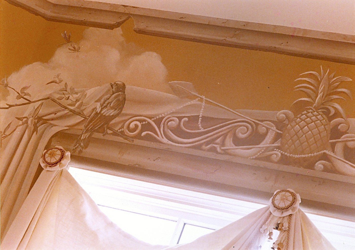 A ceiling with a painting of a pineapple on it