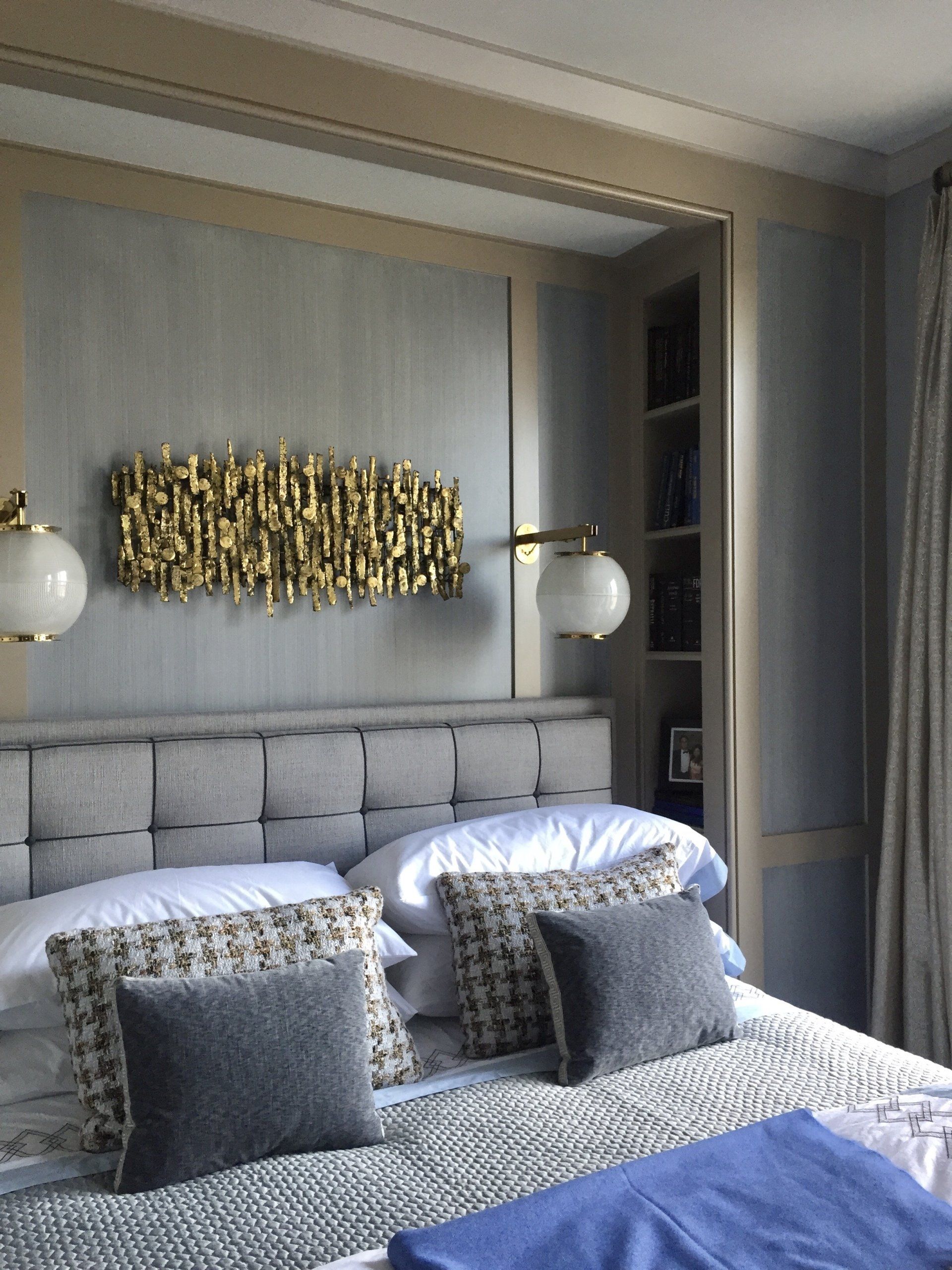 A bedroom with a bed and a large mirror on the wall