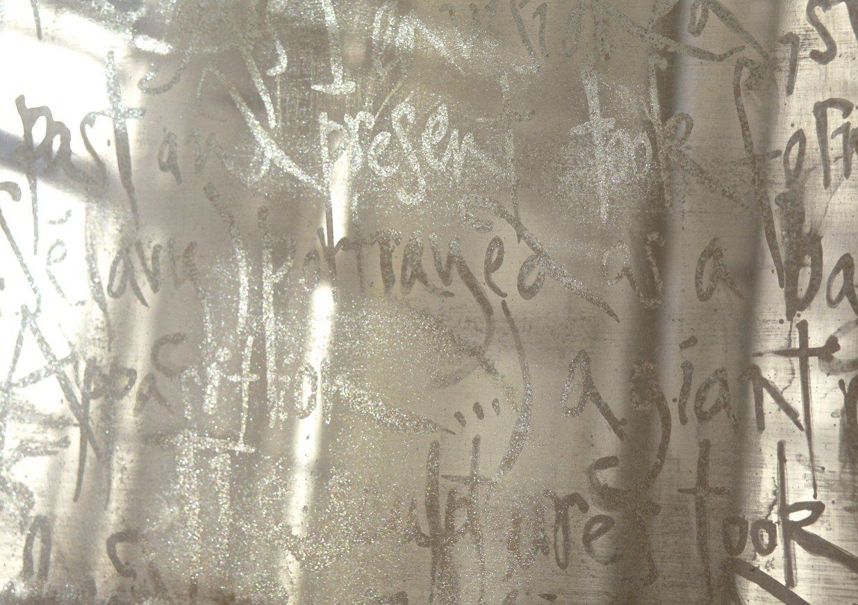 A stainless steel surface with a lot of writing on it