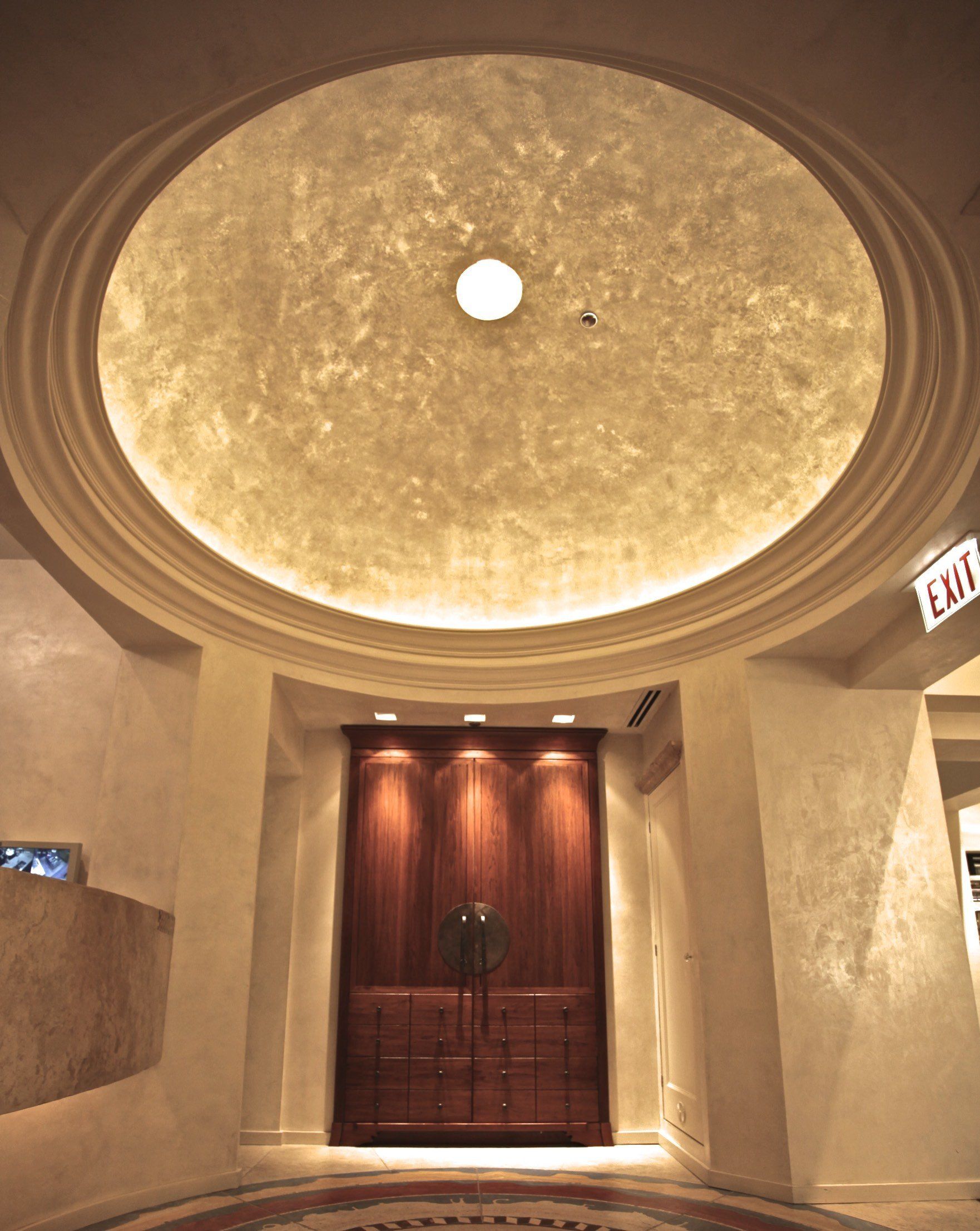 A hallway with a dome ceiling and a sign that says exit