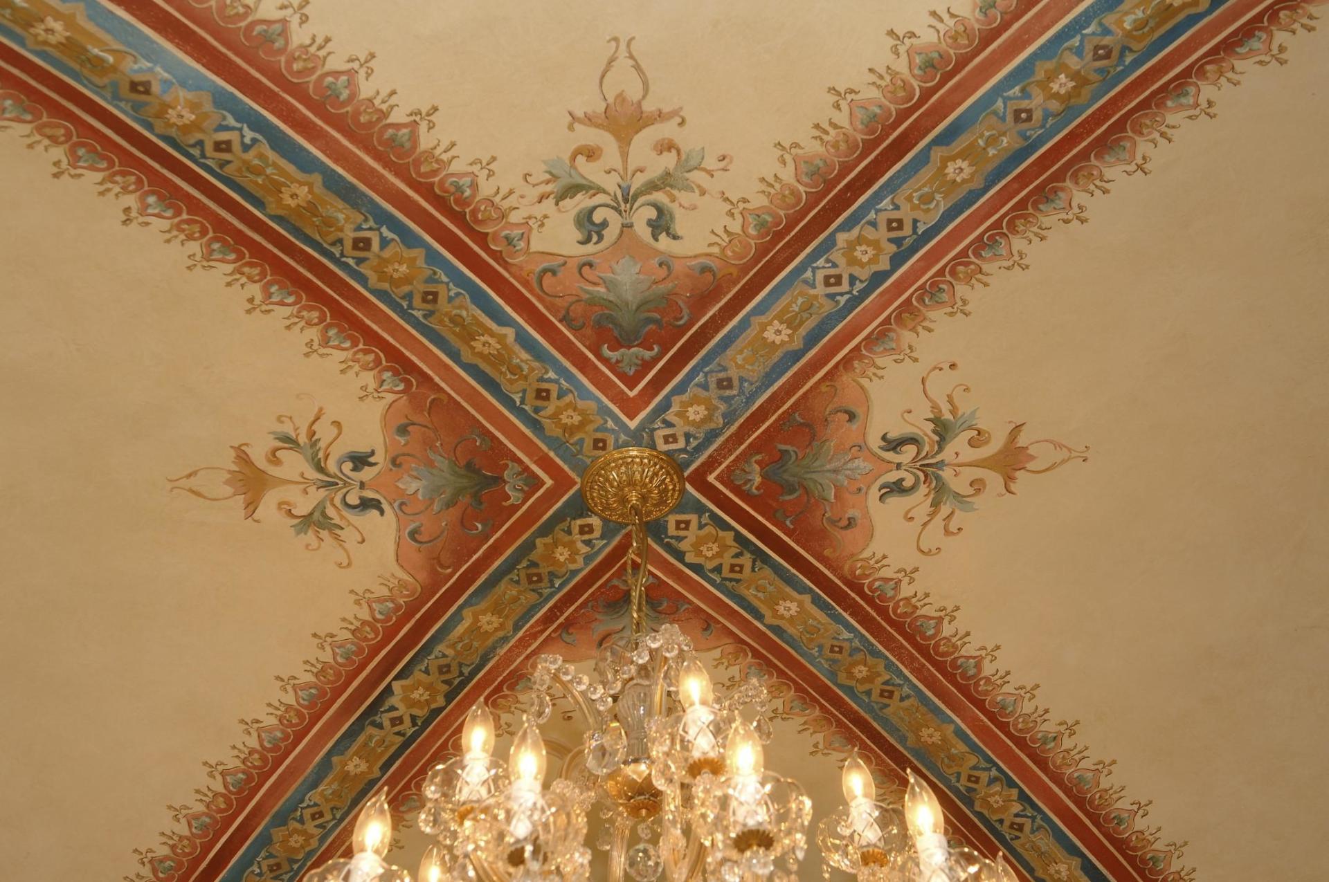 A chandelier is hanging from the ceiling of a building