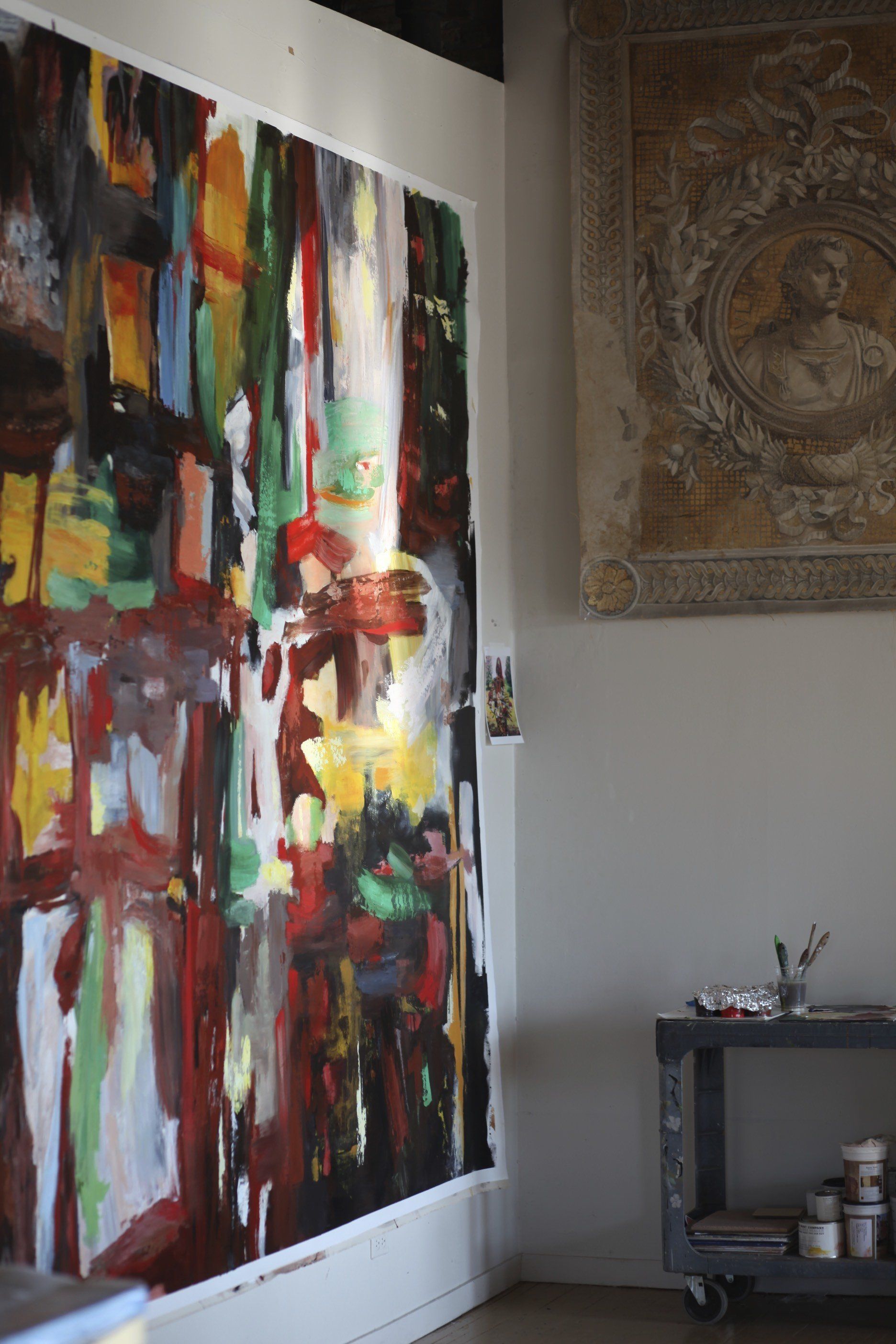 A large painting is hanging on a wall in a room