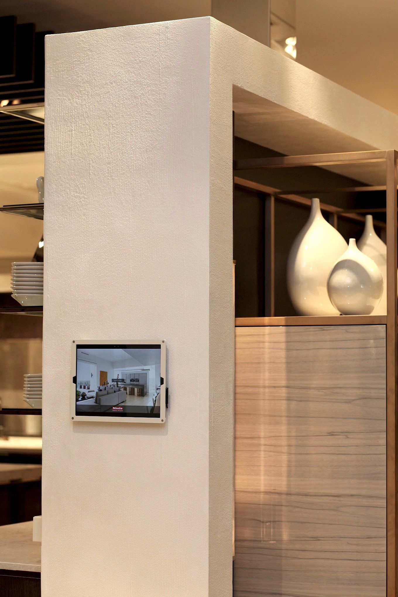 A white wall with a tablet on it