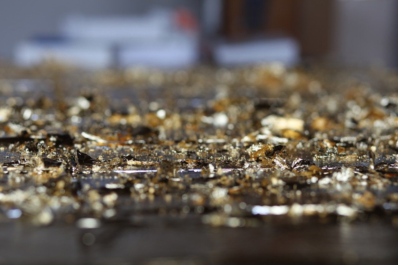 A close up of a pile of gold foil on a table.