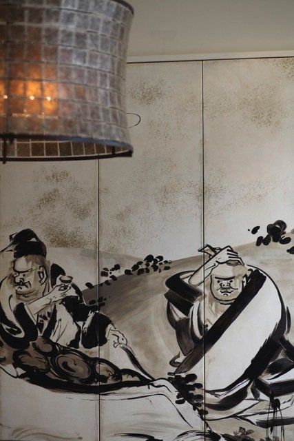 A black and white painting of two men on a wall