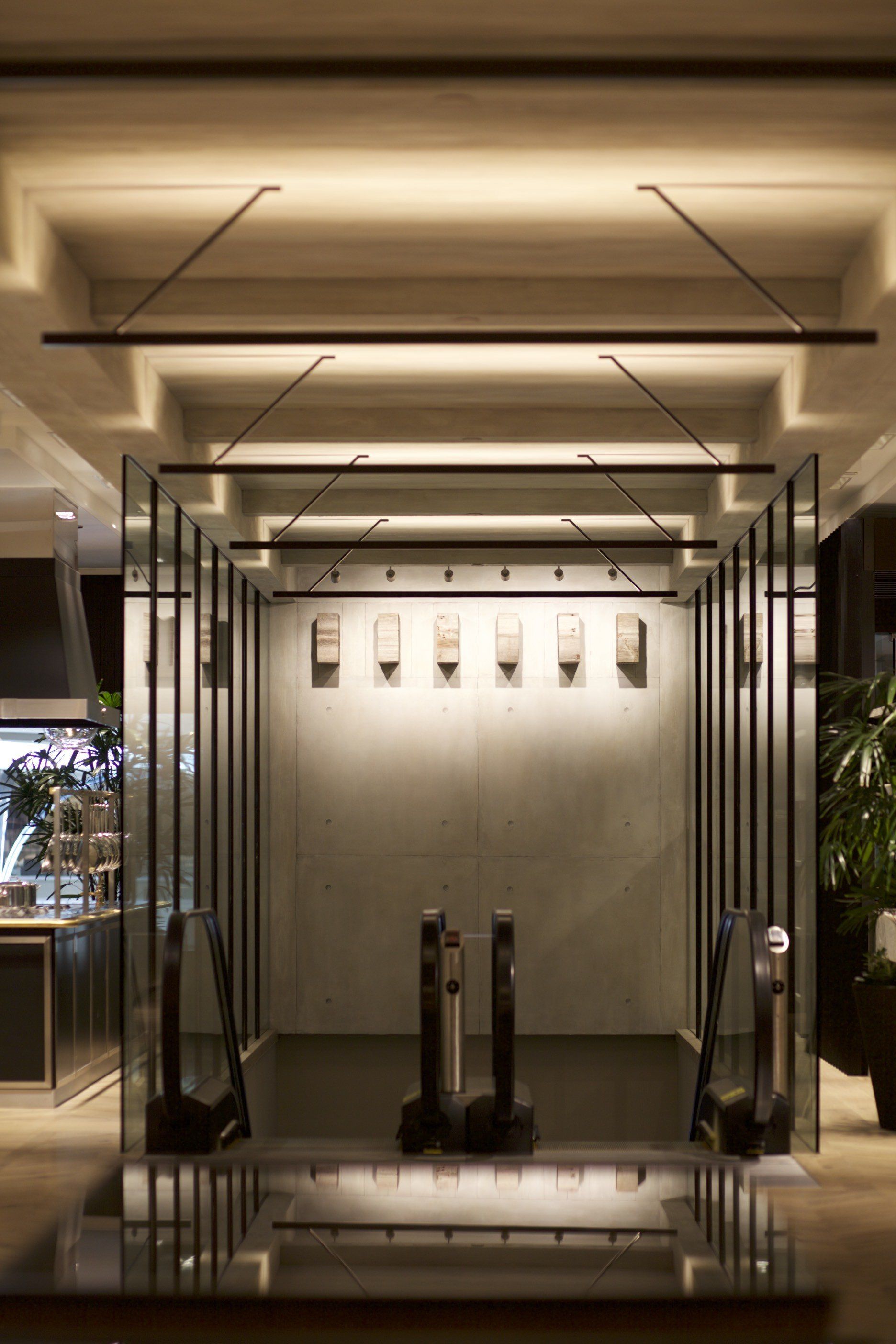 A room with a lot of mirrors and lights on the ceiling.