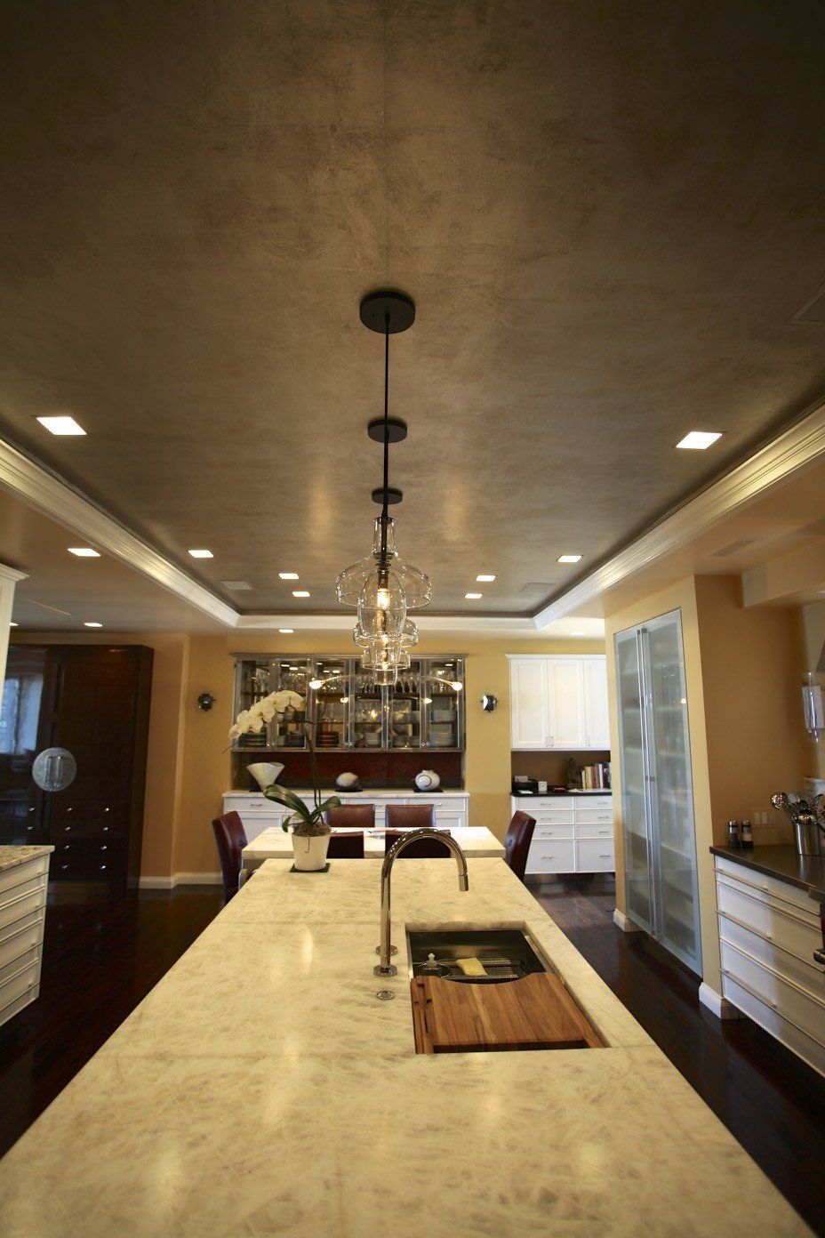 A kitchen with a large island and a sink