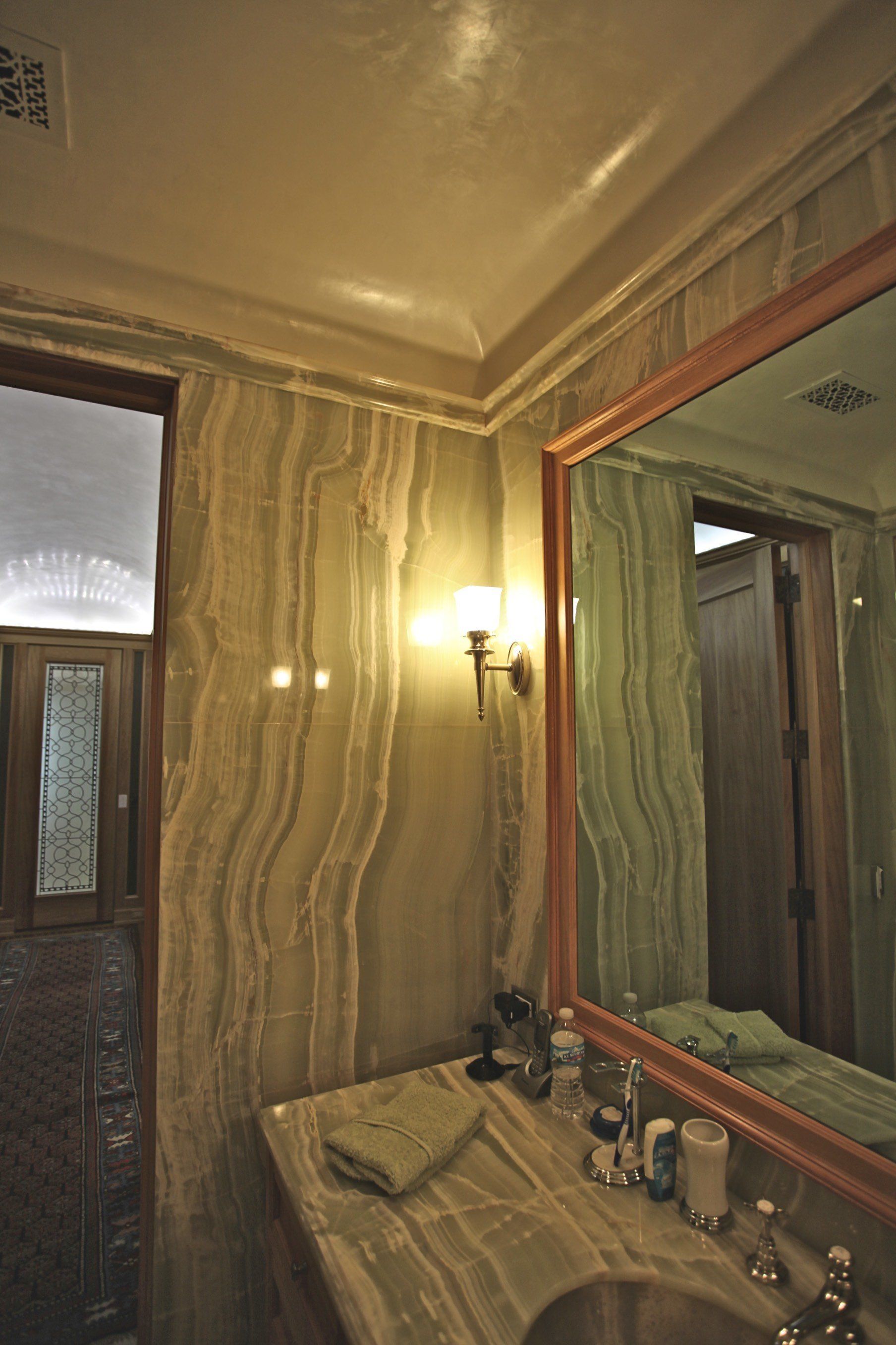 A bathroom with a sink and a large mirror
