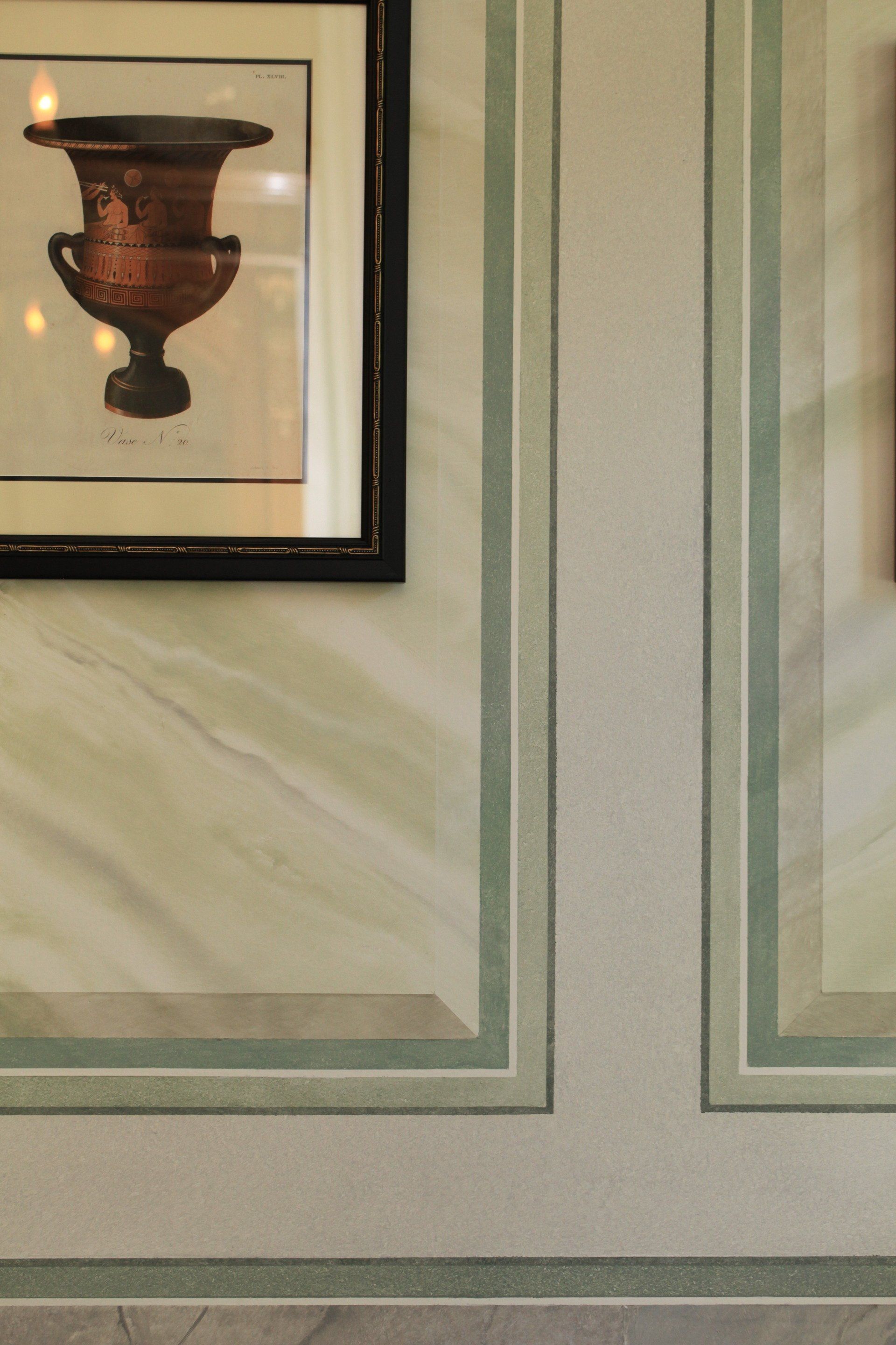 A picture of a vase is hanging on a wall