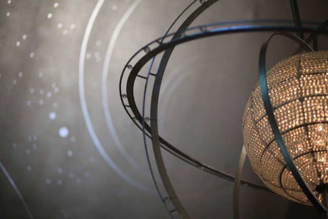 A chandelier is hanging from the ceiling in a room