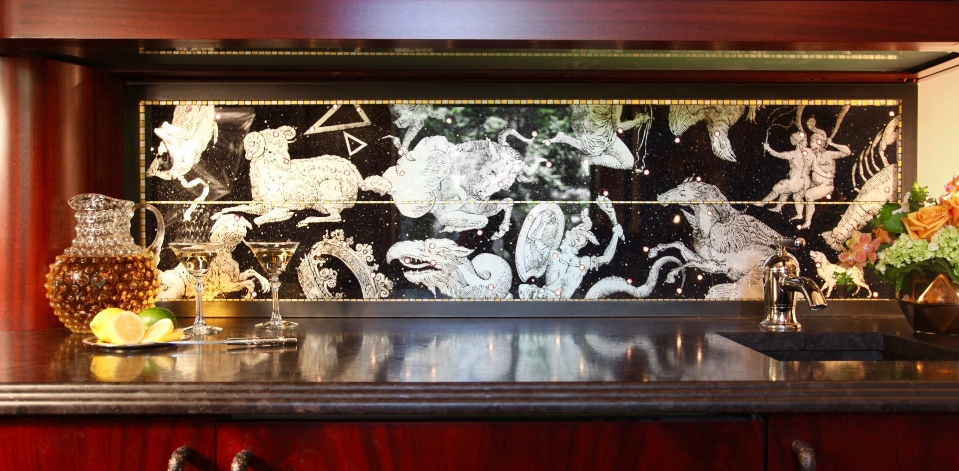 A kitchen counter with a painting on the wall above it