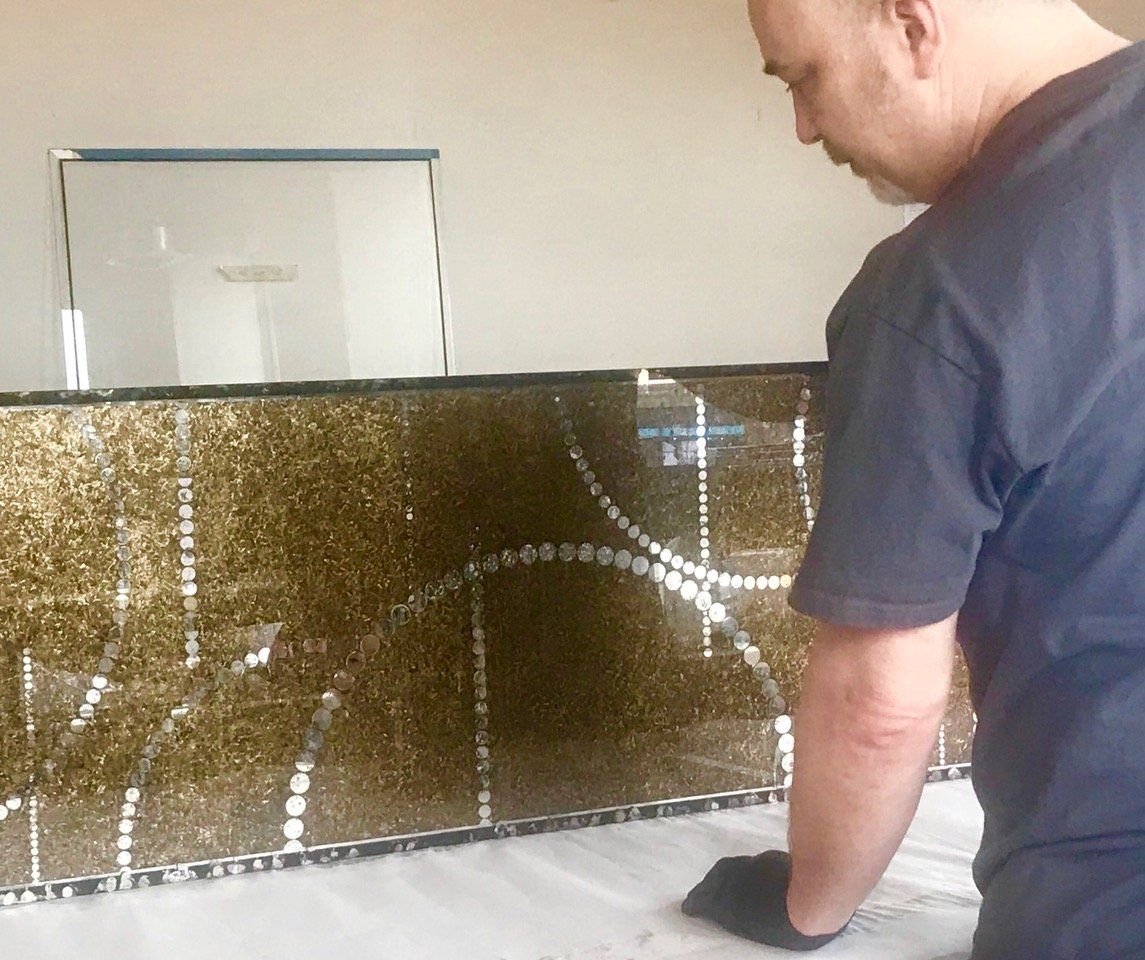 A man in a black shirt is working on a wall