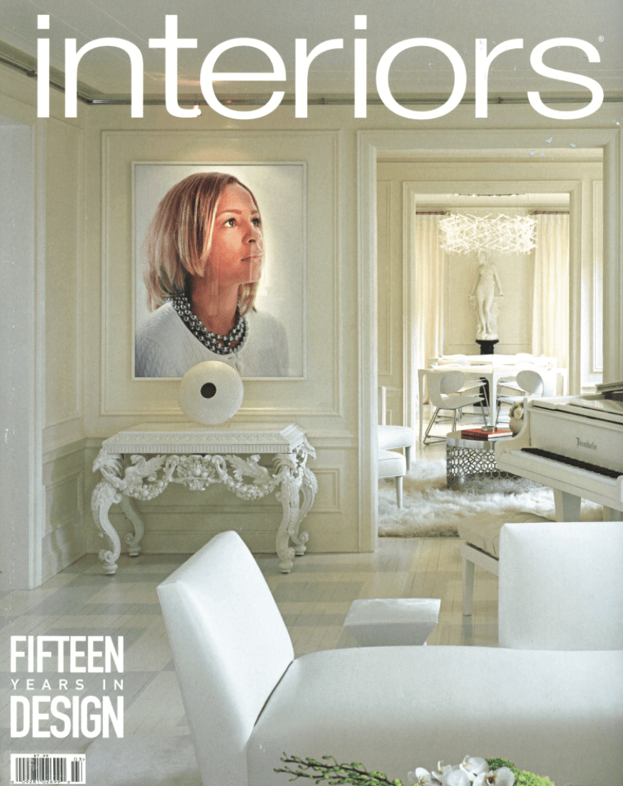A white interiors magazine with a picture of a woman on the cover