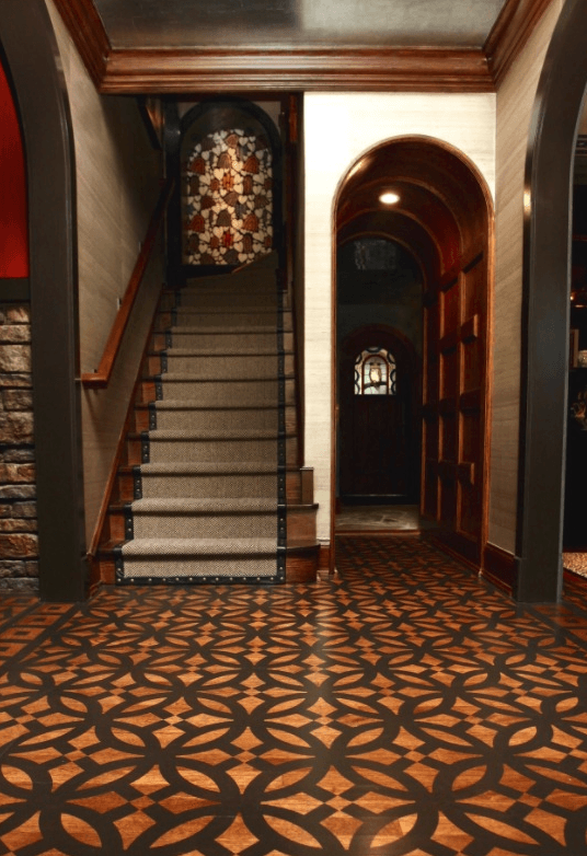 A hallway with stairs and a stained glass window