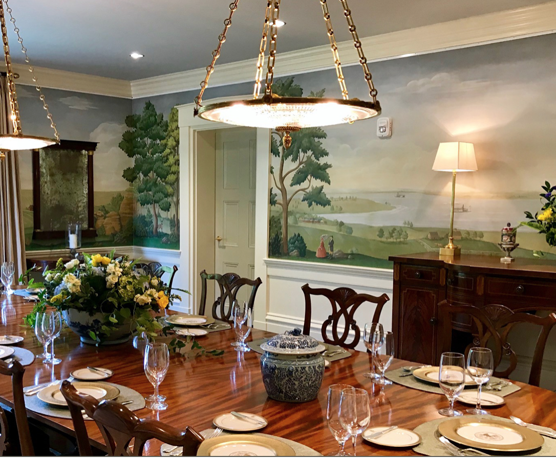 A dining room table with plates and glasses on it