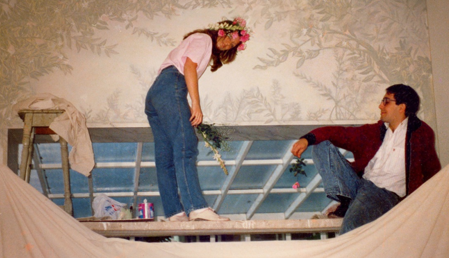 A man and a woman are standing next to each other on a stage.