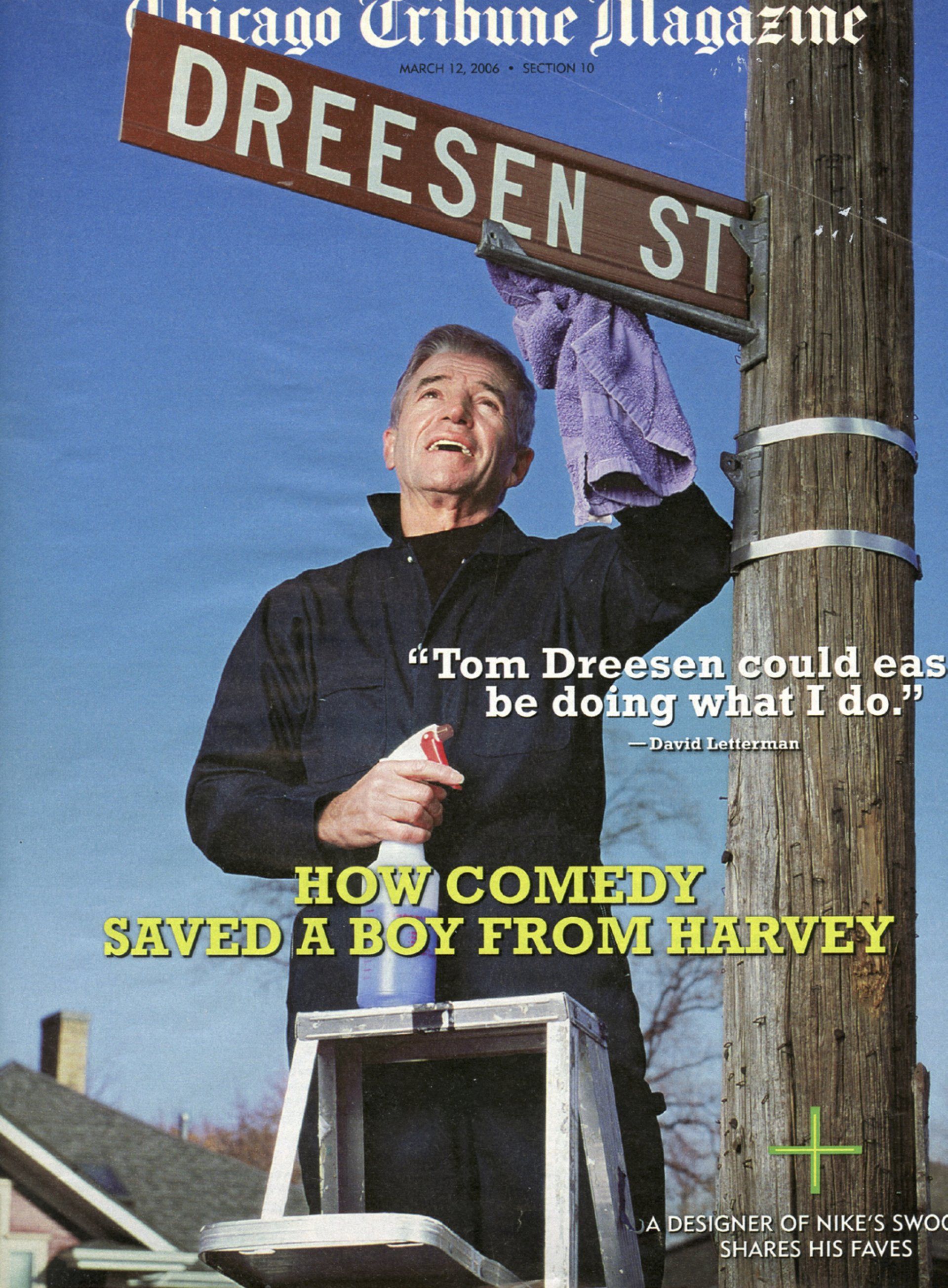A man cleaning a street sign that says dreesen st