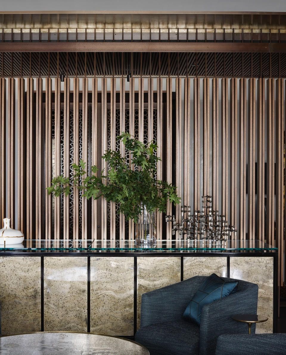 A living room with a table and chairs and a plant on it