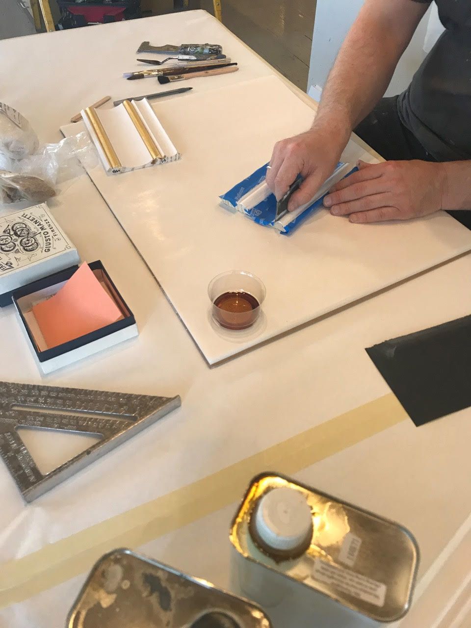 A person is working on a piece of paper on a table