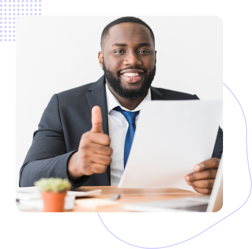 A man in a suit and tie is giving a thumbs up while holding a piece of paper.