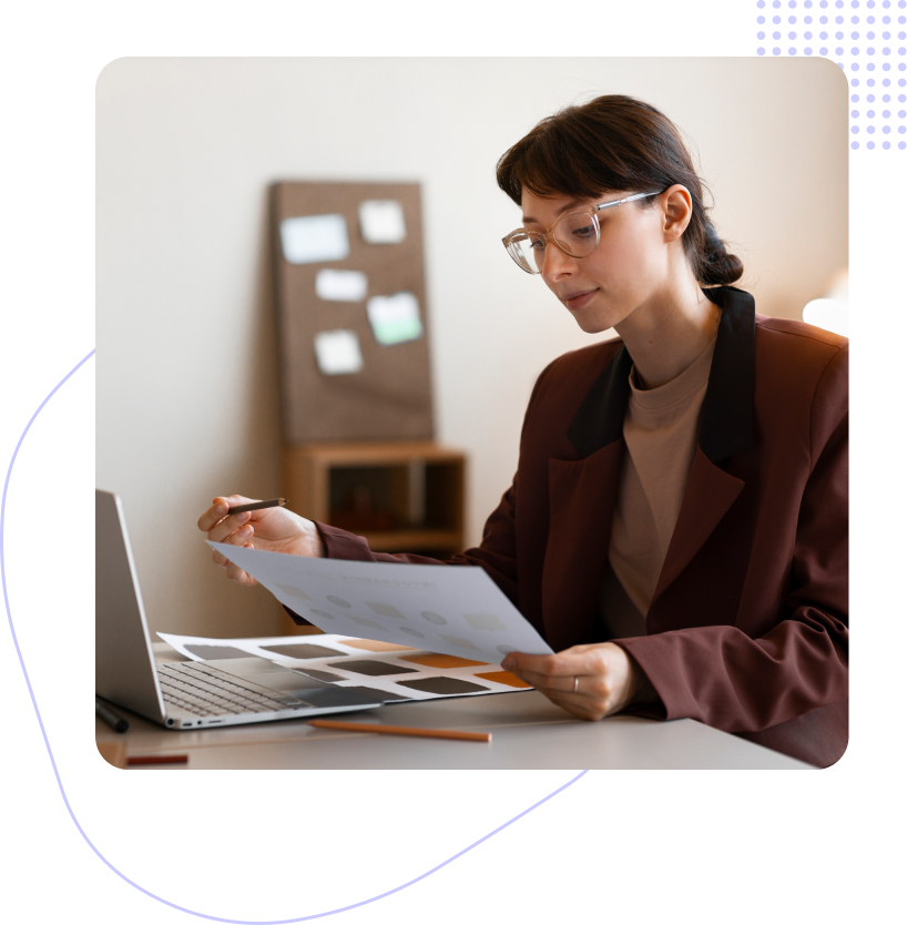 A group of people are sitting at a table having a meeting.
