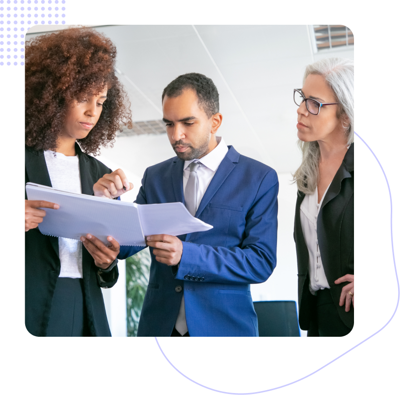 A group of people are sitting at a table having a meeting.
