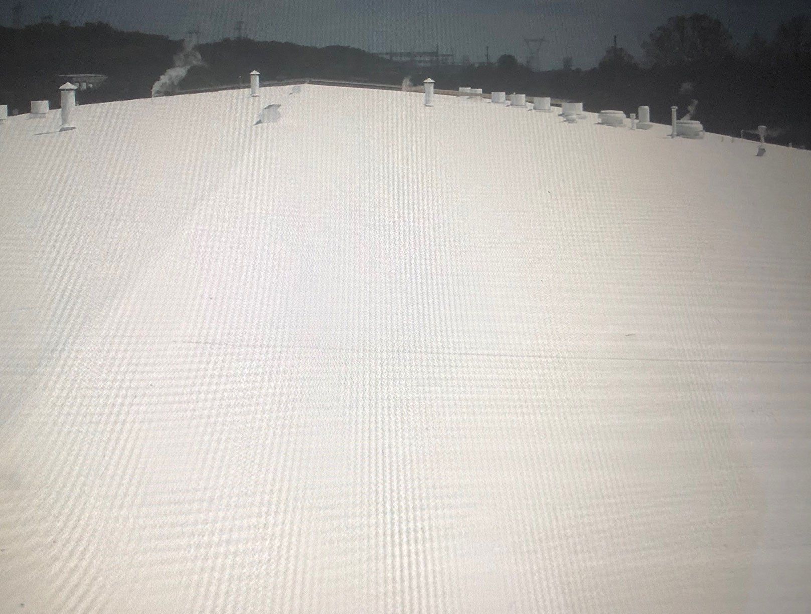 White Roof Of A Factory— Cedar Valley, IA — Raber Roofing Systems LLC.