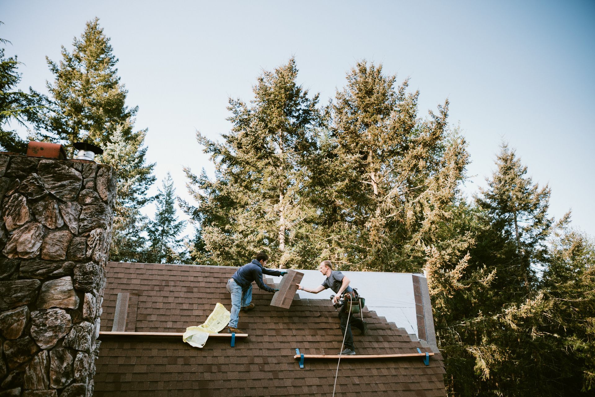 Experienced roofers installing a single roof on a residential property.