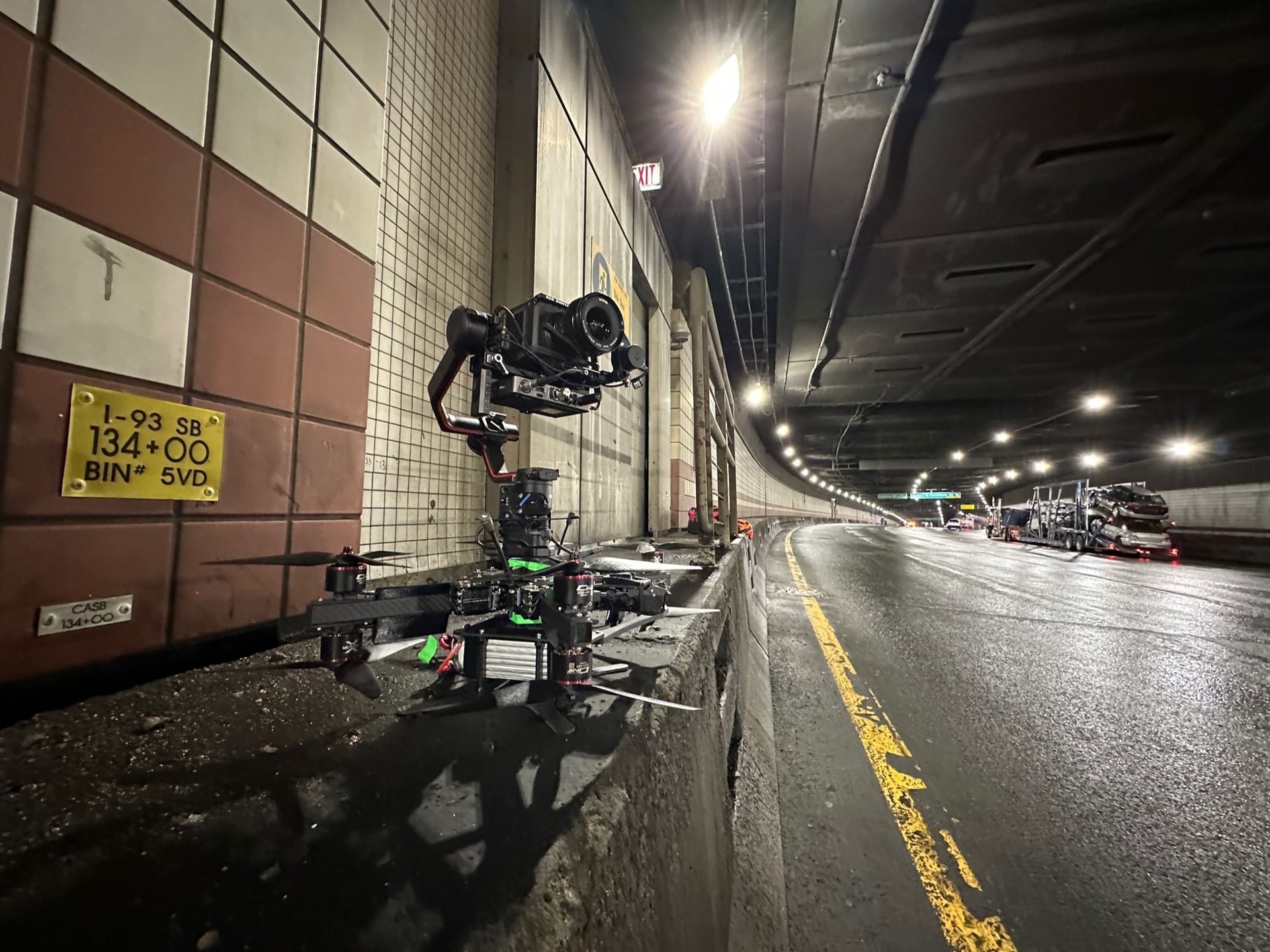 A camera is sitting on the side of a road in a tunnel.