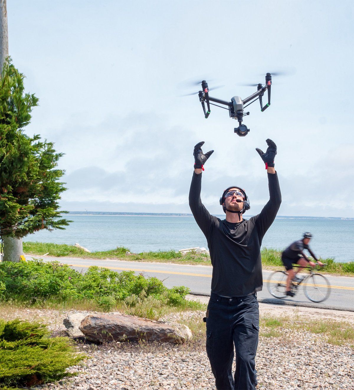 a man is throwing a drone in the air catching a drone flying